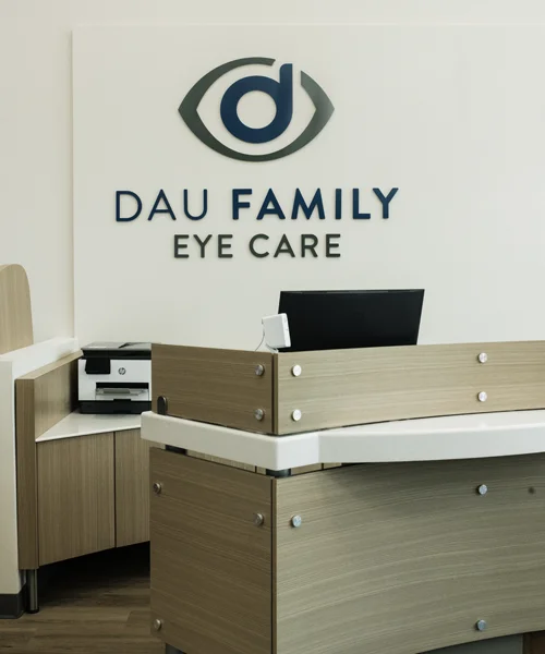 The front desk at Dau Family Eye Care with the logo on the wall
